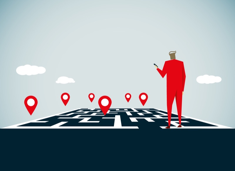 Illustration: Person prüft Standortmarkierungen auf einem Stadtplan